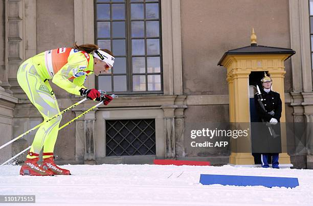 Slovenia's Petra Majdic skies past the Royal Palace honor guard during the qualification race of the ladies World Cup Royal Palace Sprint in...