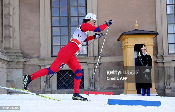 Norway's Marit Björgen skies past the Royal Palace honor guard during the qualification race of the ladies World Cup Royal Palace Sprint in...