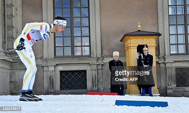 Sweden's Marcus Hellner passes the Royal Palace honor guard during the qualification race in the men's World Cup Royal Palace Sprint in Stockholm on...