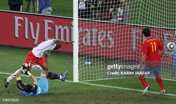 Switzerland's midfielder Gelson Fernandes scores past Spain's goalkeeper Iker Casillas as Spain's defender Joan Capdevila looks during their Group H...