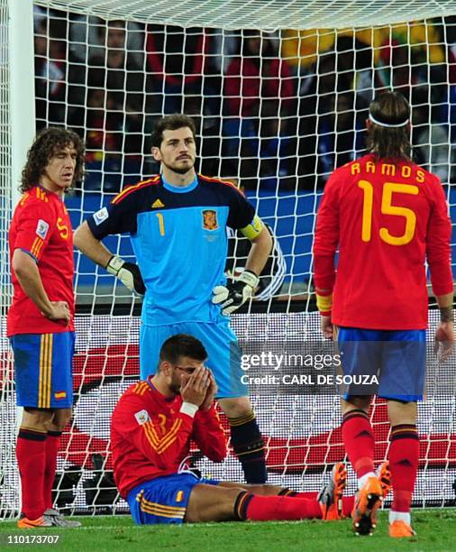 Spain's goalkeeper Iker Casillas and Spain's defender Carles Puyol , Spain's defender Sergio Ramos and Spain's defender Gerard Pique react after...