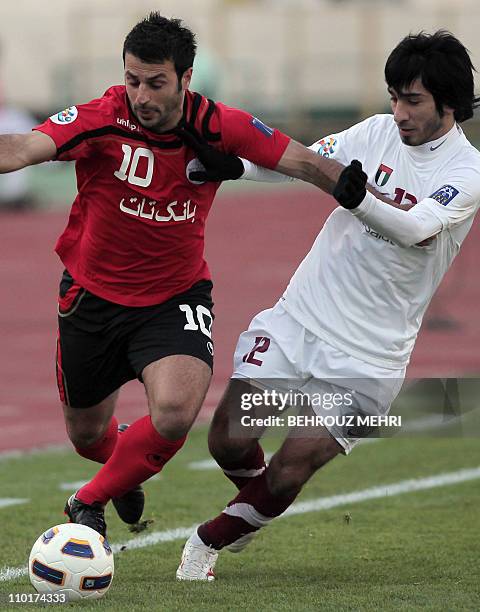 Iran's Persepolis player Gholam Reza Rezaei vies for the ball with United Arab Emirate's Al-Wahda player Khaled al-Marzuqi Jalal during their 2011...