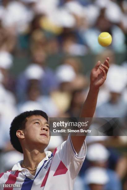 Michael Chang of the United States keeps his eyes on the ball as he prepares to serve to Stefan Edberg during the Men's Singles final match at the...