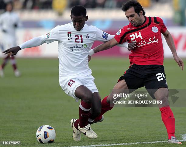 Iran's Persepolis player Hadi Norouzi challenges United Arab Emirate's Al-Wahda player Bashir Said during their 2011 AFC Champions League group C...