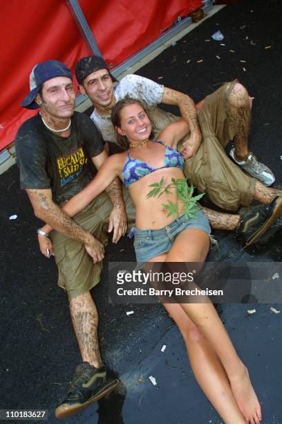 Fans at Lollapalooza covered in mud after a rainstorm which caused a delay in performances.