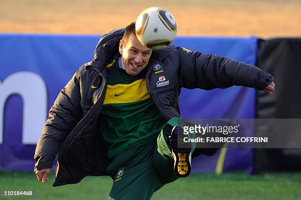 Brazil's coach Dunga plays with the ball during a training session at Randburg High School in Johannesburg on June 27, 2010 during the 2010 World Cup...