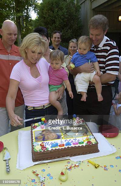 Joan Lunden and Jeff Konigsberg Hold the Twins Kate and Max Konigsberg with Pete Bolig Looking on During the Birthday Cake Cutting