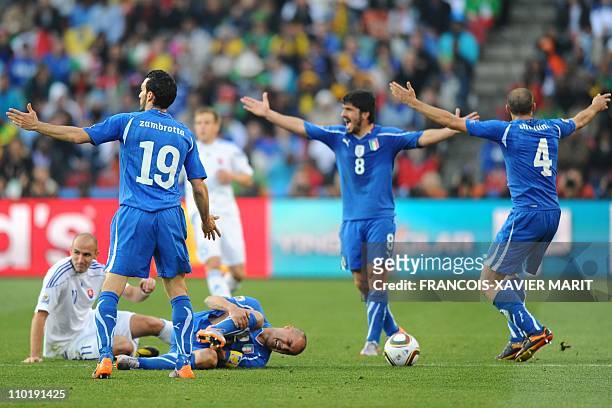 Italy's defender Fabio Cannavaro grabs his leg as Italian players appeal during the Group F first round 2010 World Cup football match between Italy...