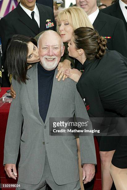 Donald P. Bellisario gets congratulatory kisses from "JAG" cast members Catherine Bell, Karri Turner and Zoe McLellan