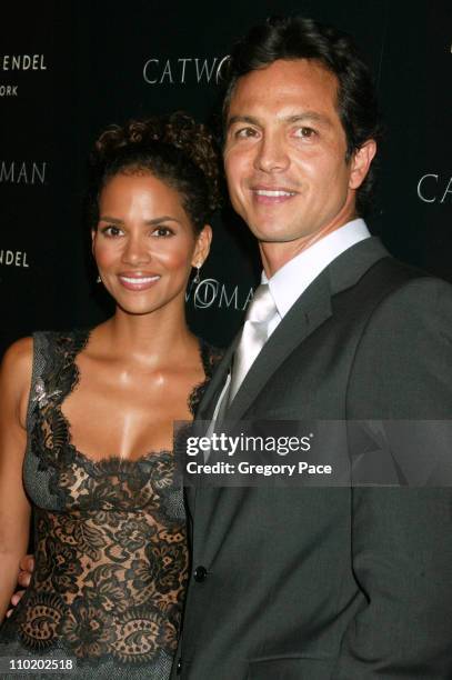 Halle Berry and Benjamin Bratt during Warner Bros. Consumer Products and Henri Bendel Host Purr-fect "Catwoman" at Henri Bendel in New York City, New...