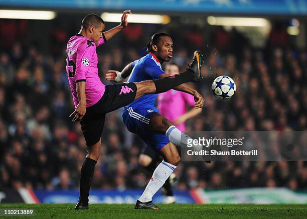 Mathias Zanka Jorgensen of FC Copenhagen challenges Didier Drogba of Chelsea during the UEFA Champions League round of sixteen second leg match...