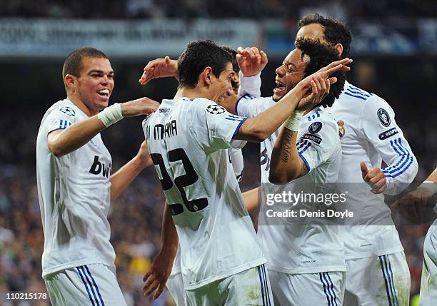 Angel Di Maria of Real Madrid celebrates with Marcelo after scoring Real's third goal during the UEFA Champions League round of 16 second leg match...