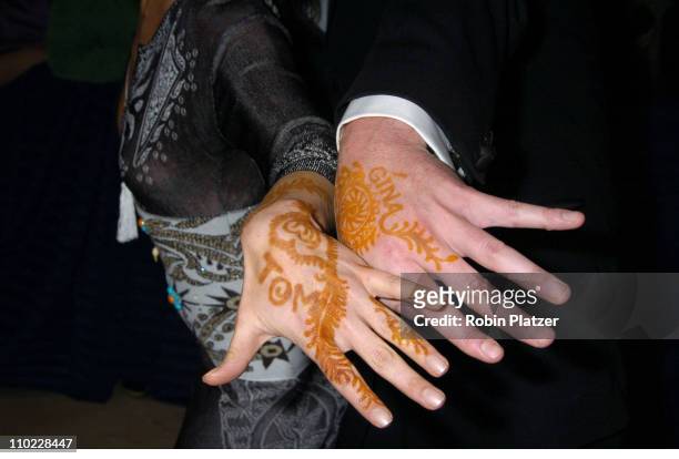 Gina Tognoni and Tom Pelphrey showing off henna tattoos of each others names