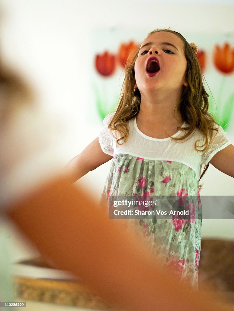 Mirror image of girl singing her heart out