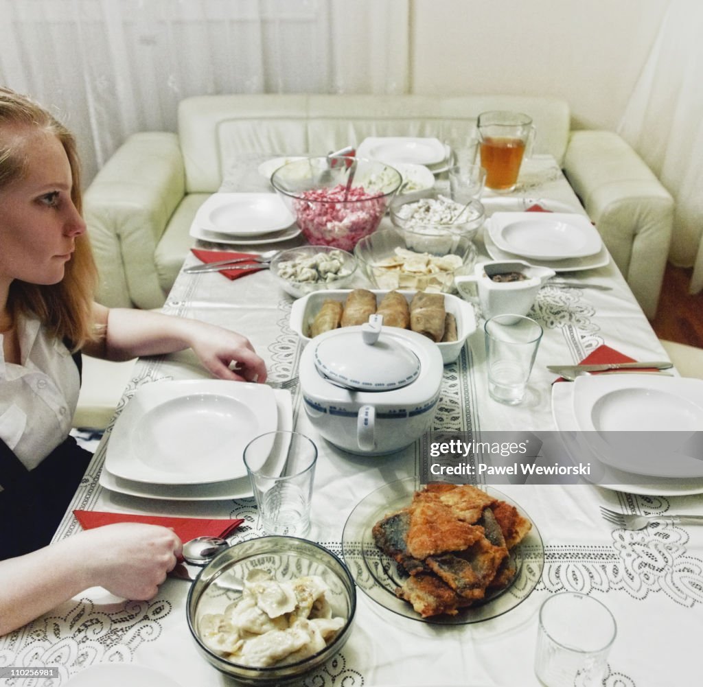 Girl infront of traditional polish christmas dinne