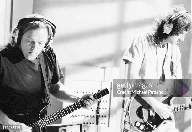 David Gilmour of Pink Floyd and Brian May of Queen in recording studio during making of Armenia earthquake appeal record, London, 1989. He plays a...