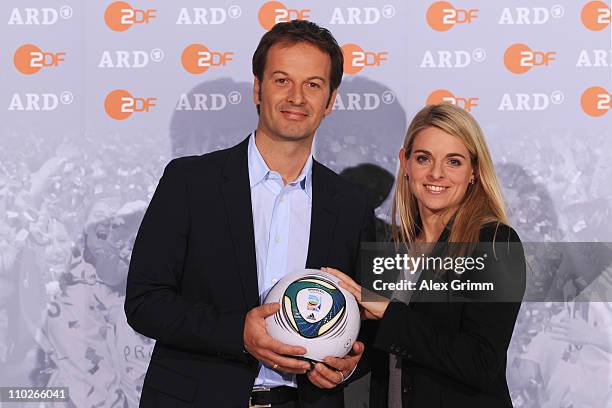 Claus Lufen and Nia Kuenzer pose during a photocall with the ARD and ZDF TV presenters for the FIFA Women World Cup 2011 at the Commerzbank Arena on...