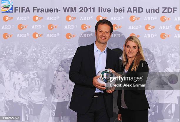 Claus Lufen and Nia Kuenzer pose during a photocall with the ARD and ZDF TV presenters for the FIFA Women World Cup 2011 at the Commerzbank Arena on...