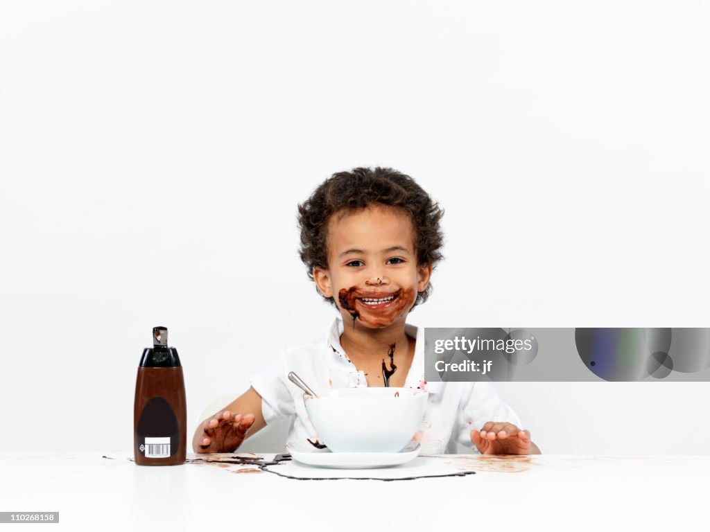 Boy covered in chocolate sauce