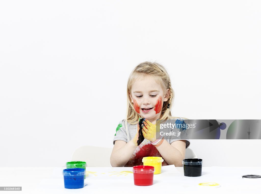 Girl playing with finger paint