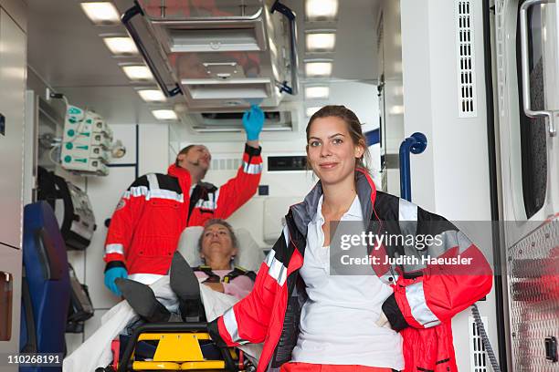 ambulance team with patient in coach - paramedics stock-fotos und bilder