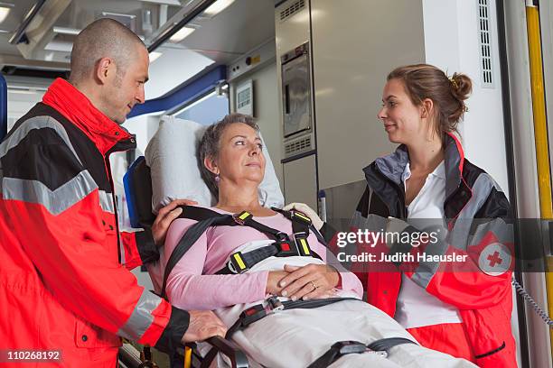 ambulance team caring about woman - paramedic emergency stock pictures, royalty-free photos & images