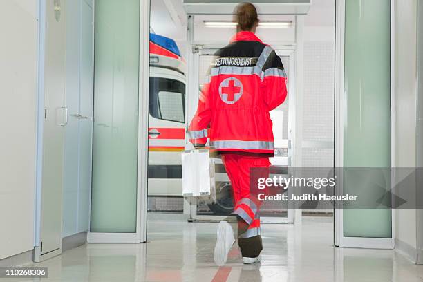back of paramedic rushing at hall - vehículo de emergencia fotografías e imágenes de stock
