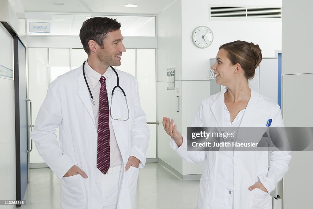 Nurse and doctor discussing in hall