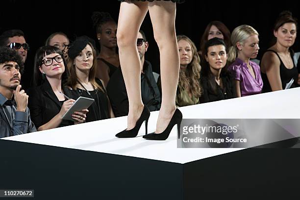 audience watching model on catwalk at fashion show, low section - leg show stock pictures, royalty-free photos & images