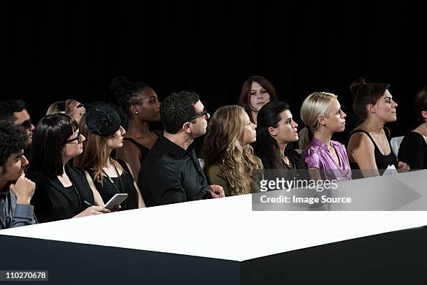 audience at fashion show watching empty catwalk - fashion show stock pictures, royalty-free photos & images