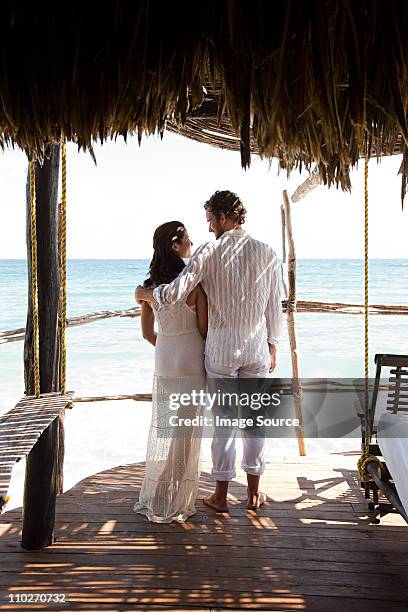 mid adult couple on vacation in beach hut - mid adult couple stockfoto's en -beelden