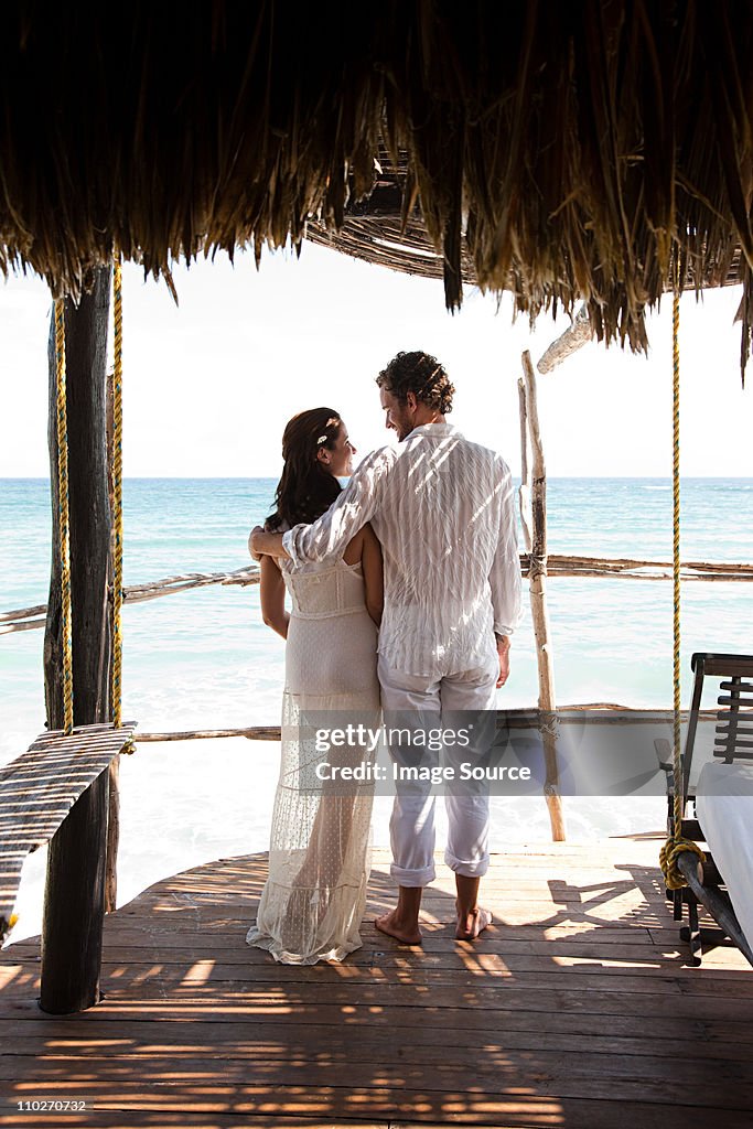 Mid adult couple on vacation in beach hut