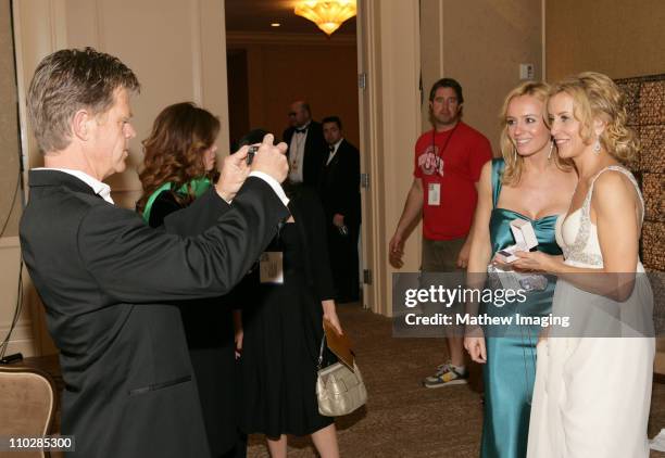 William H. Macy takes a photograph of his wife Felicity Huffman, winner of Best Performance by an Actress in a Motion Picture - Drama for...