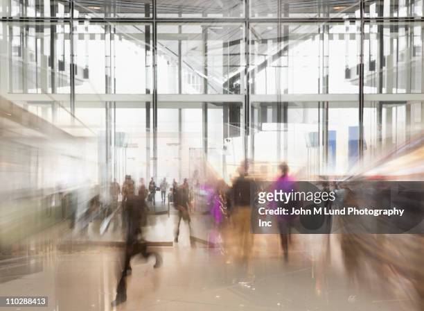 busy people rushing in lobby - airport indoor stock pictures, royalty-free photos & images