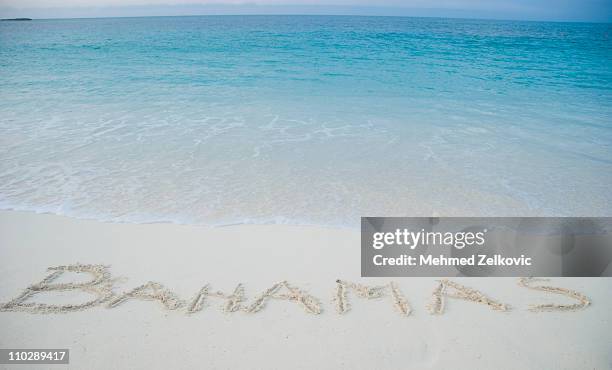 bahamas written in sand - atlantis resort paradise island stock pictures, royalty-free photos & images