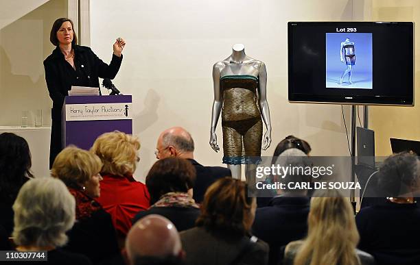 An auctioneer takes bids for a see-through dress worn by Kate Middleton, fiancee of Britain's Prince William during her student days at Kerry Taylor...