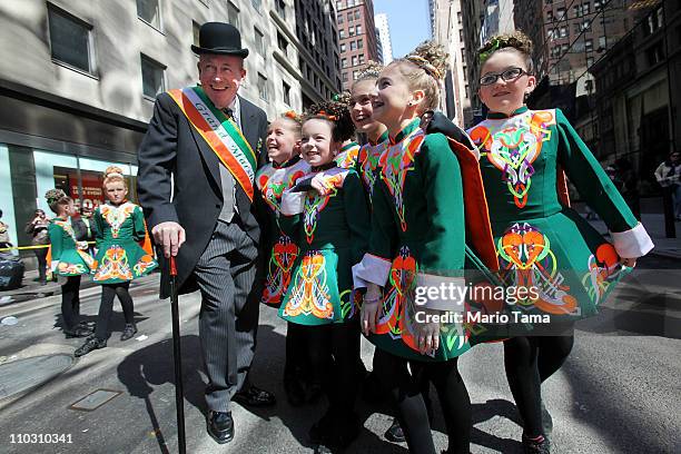 Donny Golden shares a laugh with dancers from the Irish American Society during the 250th annual St. Patrick's Day parade March 17, 2011 in New York...