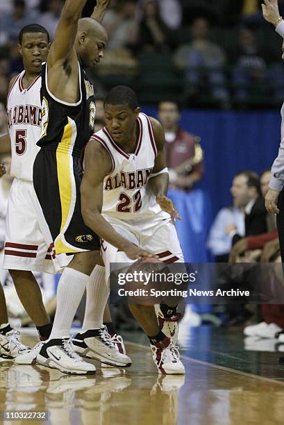 College Basketball - University of Wisconsin-MIlwaukee Ed McCants against Alabama Ronald Steele during the first round of the NCAA Tournament on...