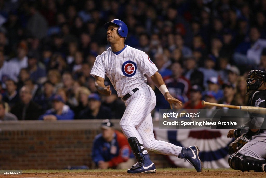 15 Oct 2003: Moises Alou of the Chicago Cubs watches the flight of the ball after hitting a home run during the Cubs 9-6 loss to the Florida Marlins in game 7 of the NLCS at Wrigley Field in Chicago, IL.