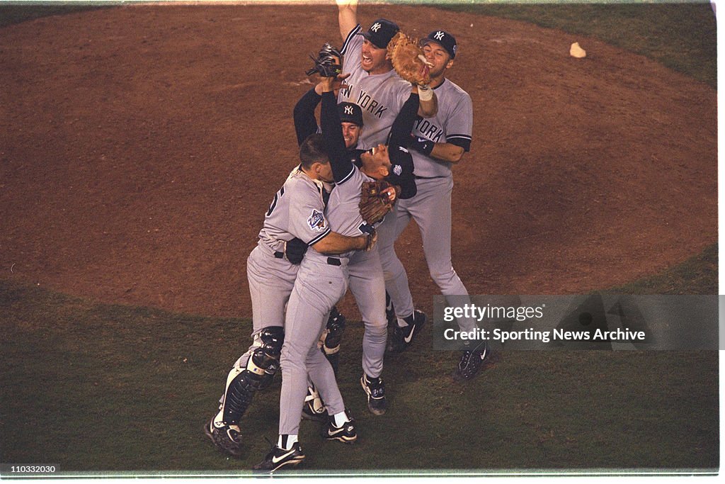 21 October 1998: Mariano Rivera of the New York Yankees is mobbed by his teammates after the Yanks 3-0 victory over the San Diego Padres in game four of the World Series at Qualcomm Stadium in San Diego, CA.