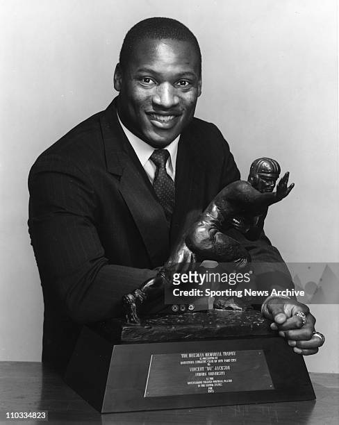 Auburn's Bo Jackson poses with his 1985 Heisman Trophy.