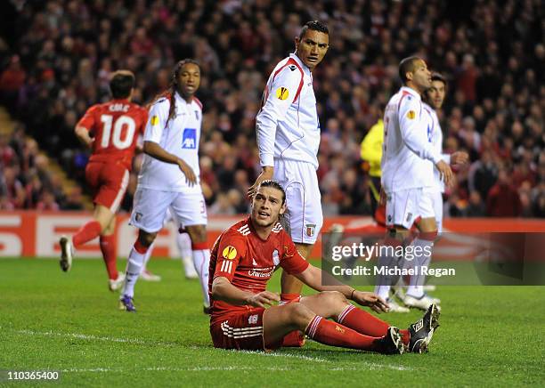 Andy Carroll of Liverpool remonstrates as he sits on the pitch during the UEFA Europa League Round of 16 second leg match between Liverpool and SC...