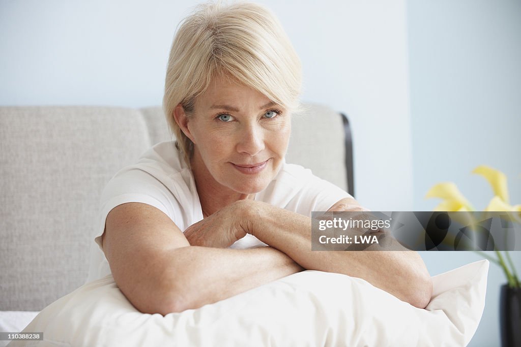Senior Woman Sitting On Bed