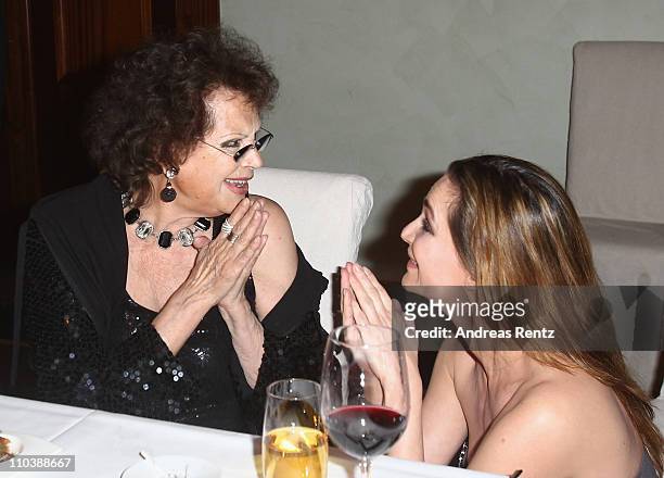 Claudia Cardinale chats with Alexandra Kamp during the reception to the 150th anniversary of Italy unification at the Italian embassy to Germany on...