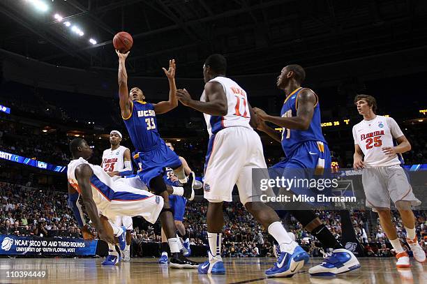 Orlando Johnson of the UC Santa Barbara Gauchos drives for a shot attempt against Vernon Macklin of the Florida Gators during the second round of the...