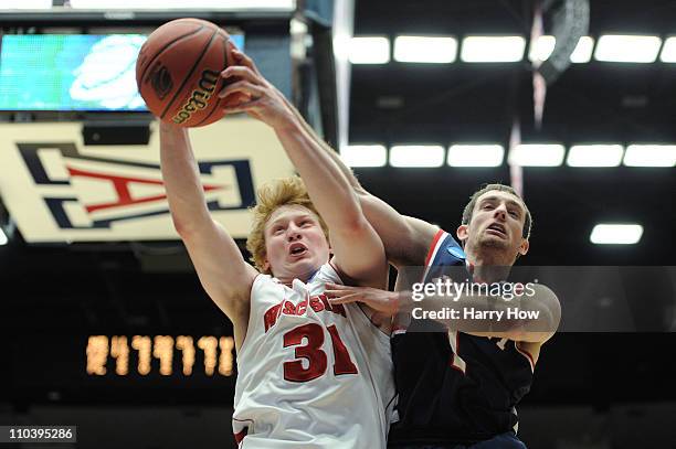 Mike Bruesewitz of the Wisconsin Badgers pulls down a rebound against Drew Hanlen of the Belmont Bruins during the second round of the 2011 NCAA...