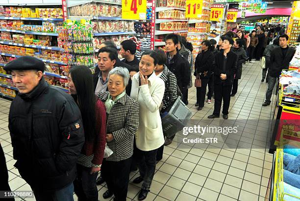 In a picture taken on March 17, 2011 Chinese shoppers crowd a shop in an effort to buy salt in Lanzhou, northwest China's Gansu province. Chinese...