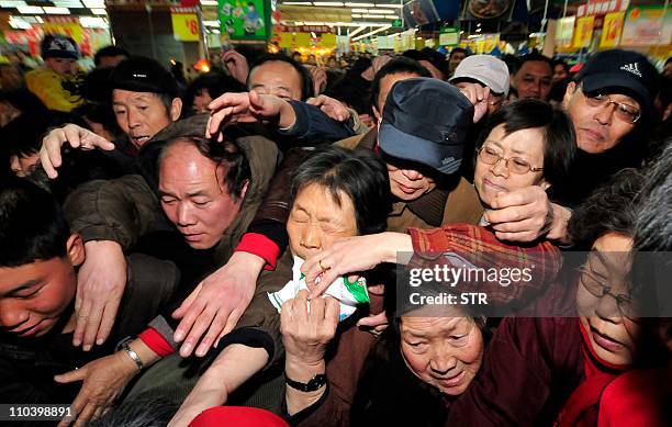 In a picture taken on March 17, 2011 Chinese shoppers crowd a shop in an effort to buy salt in Lanzhou, northwest China's Gansu province. Chinese...