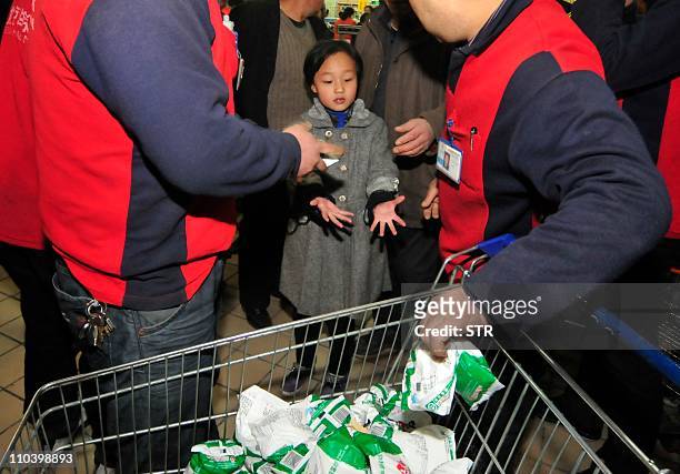 In a picture taken on March 17, 2011 Chinese shoppers crowd a shop in an effort to buy salt in Lanzhou, northwest China's Gansu province. Chinese...