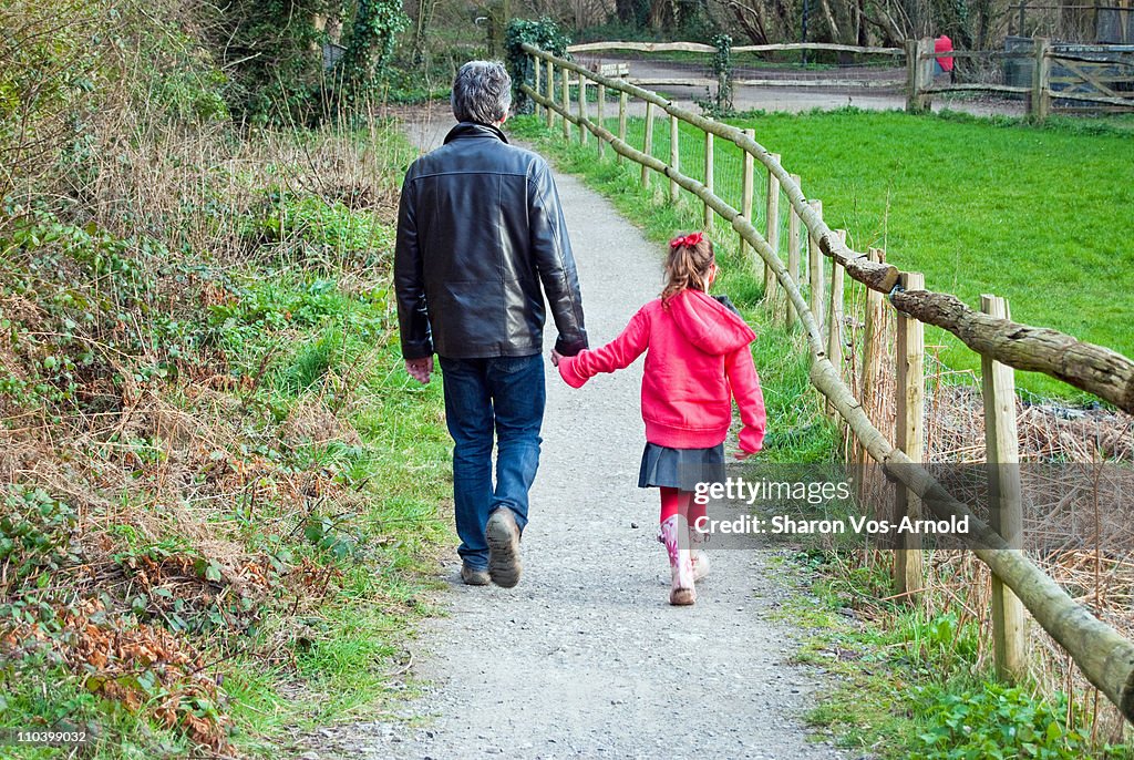 Young girl walking with her dad